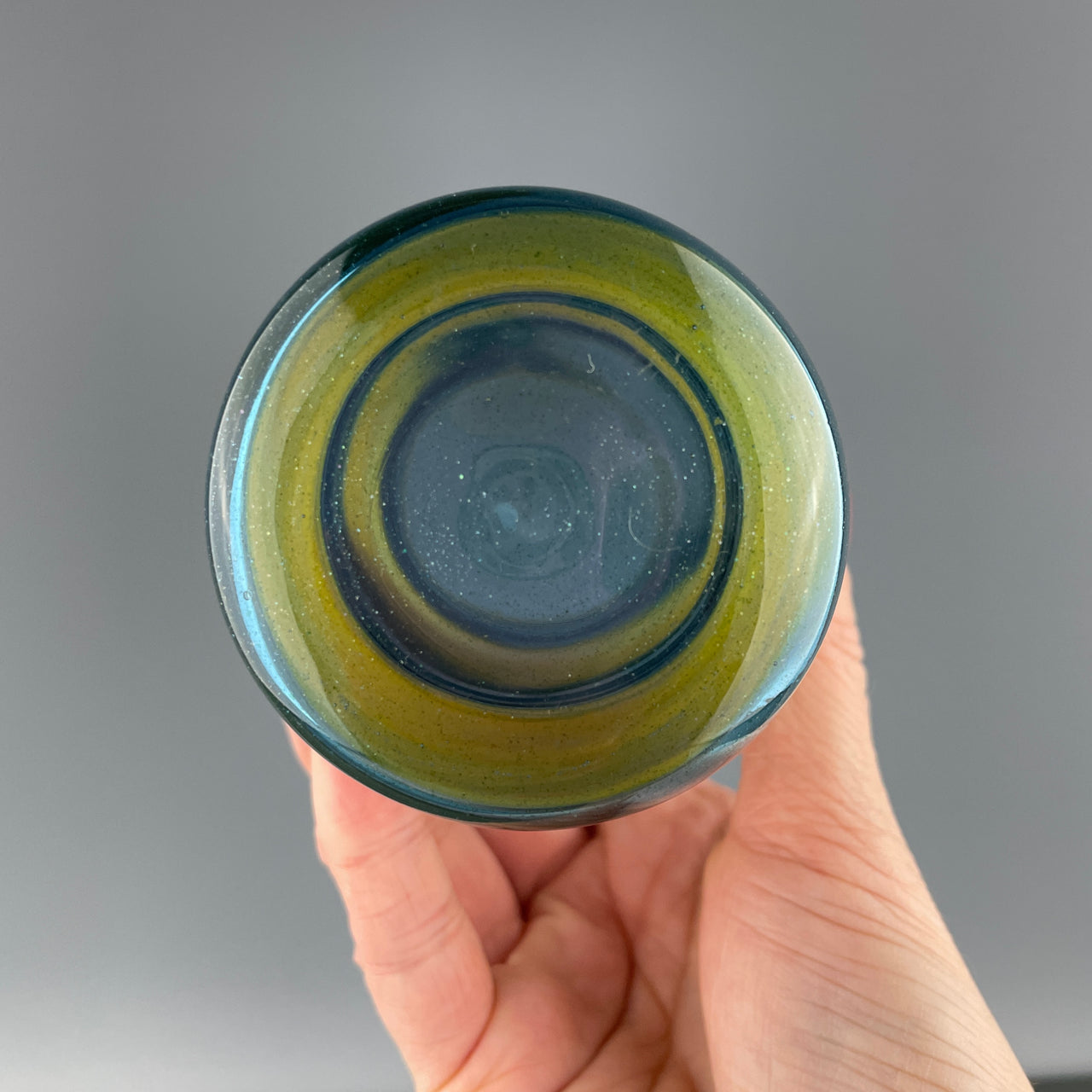 bottom of a blue and yellow striped cup