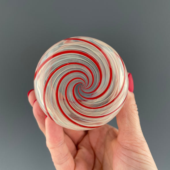 bottom of a clear cup with red swirls