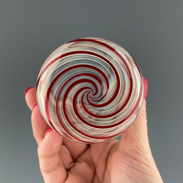 bottom of a clear cup with ruby red swirls