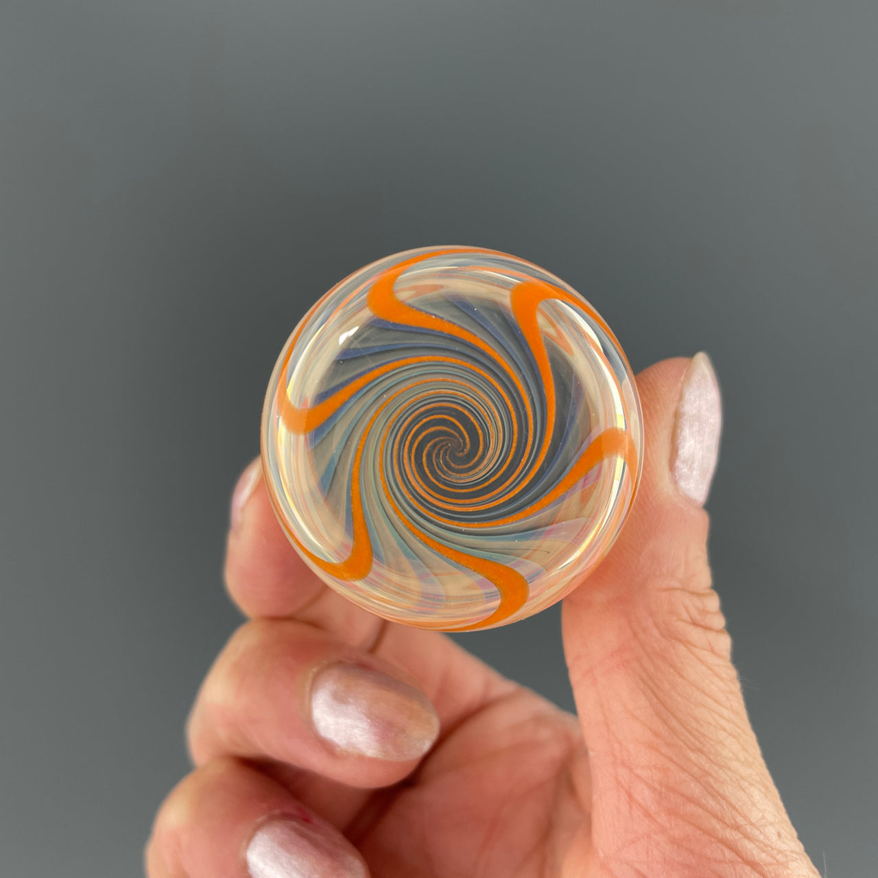 bottom of a clear and orange shot glass