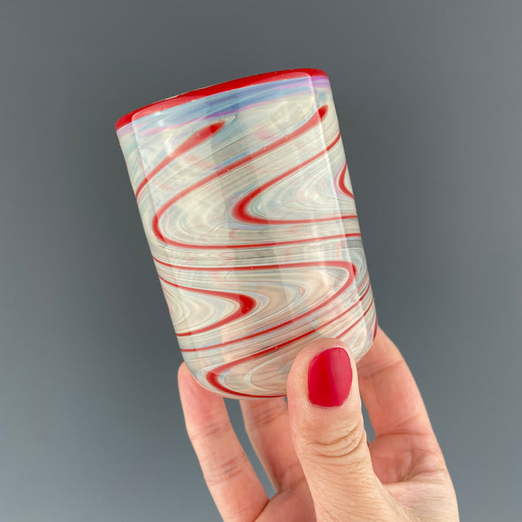 clear cup with red swirls