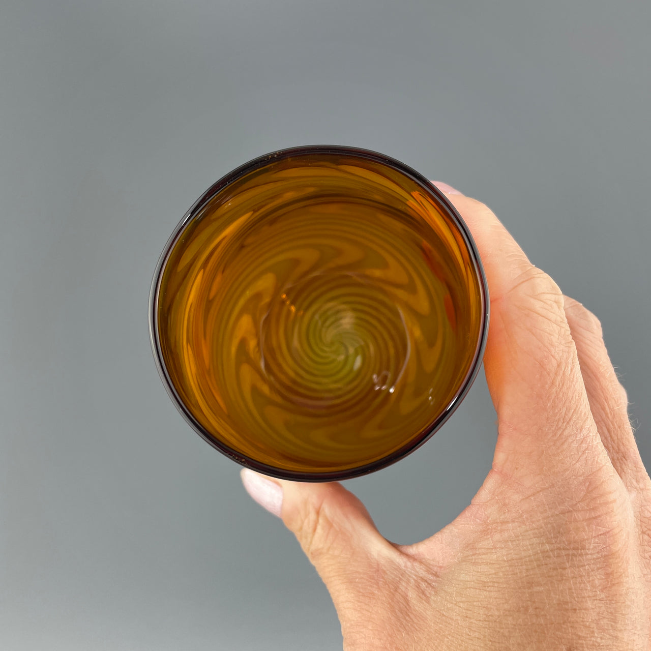 inside of an amber and silver stemless wineglass