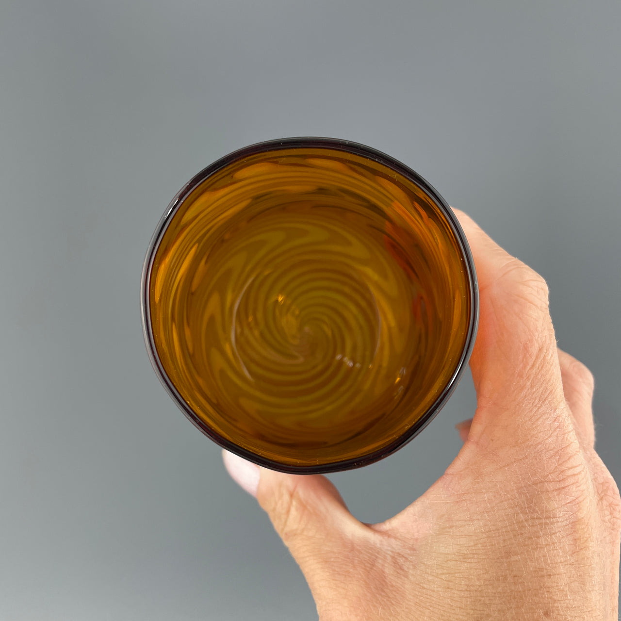 inside of an amber and silver stemless wineglass