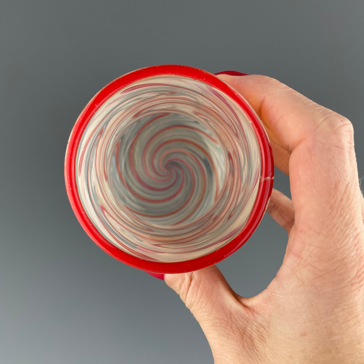 inside of a clear cup with red swirls