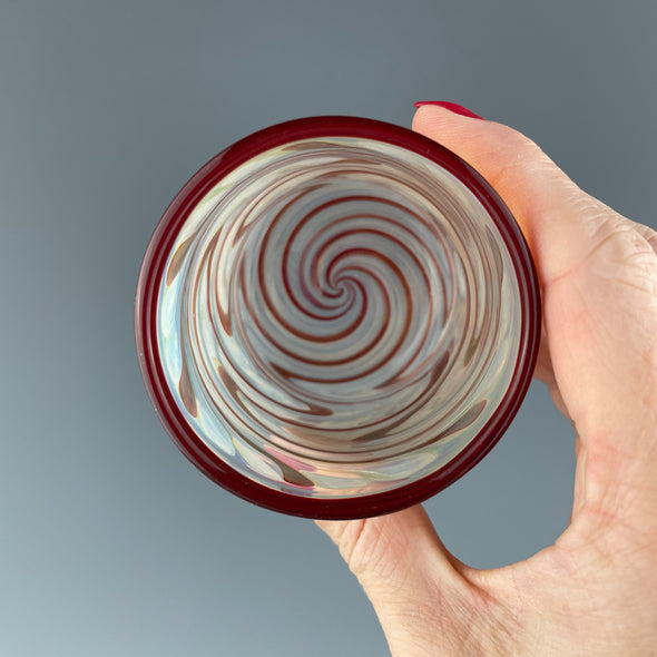 inside of a clear cup with ruby red swirls