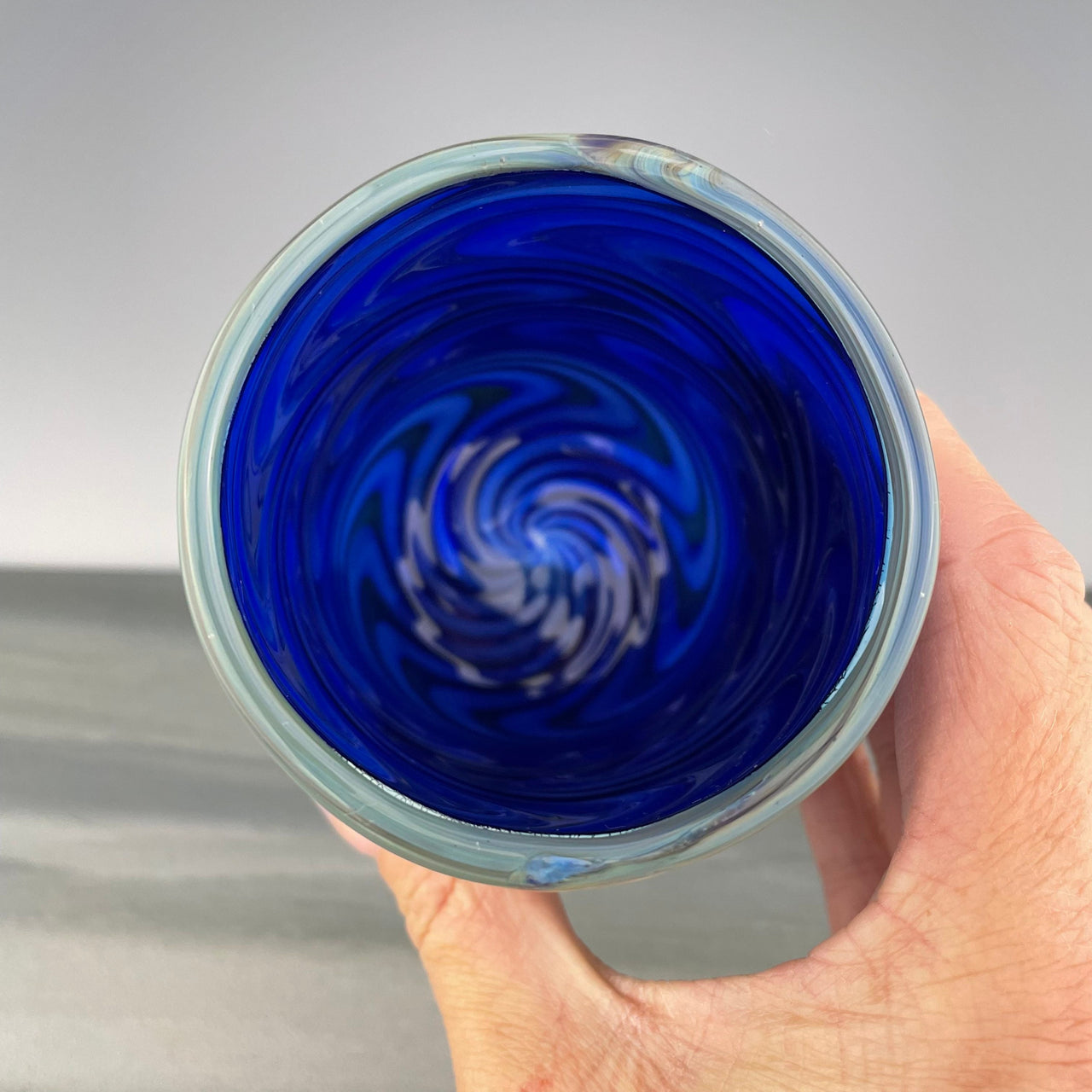 inside of a cobalt blue cup with a grey rim