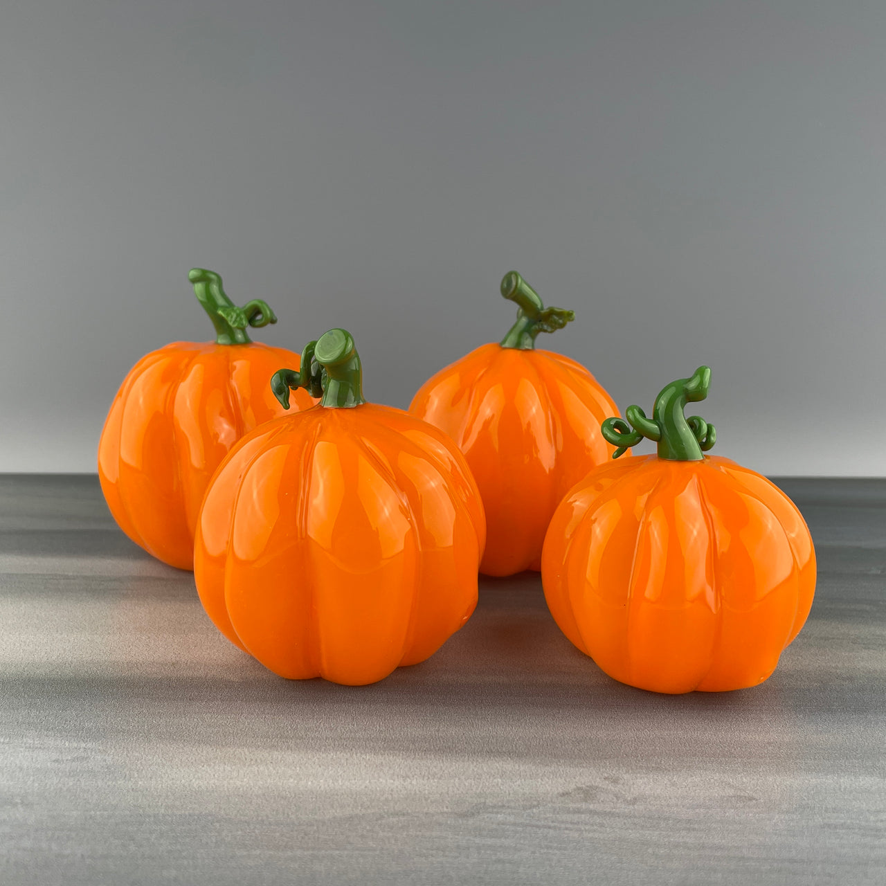 set of four glass pumpkins