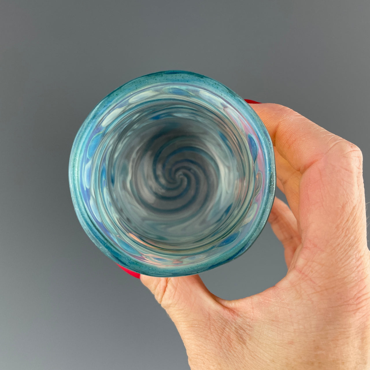 inside of a clear and blue sparkle swirls cup