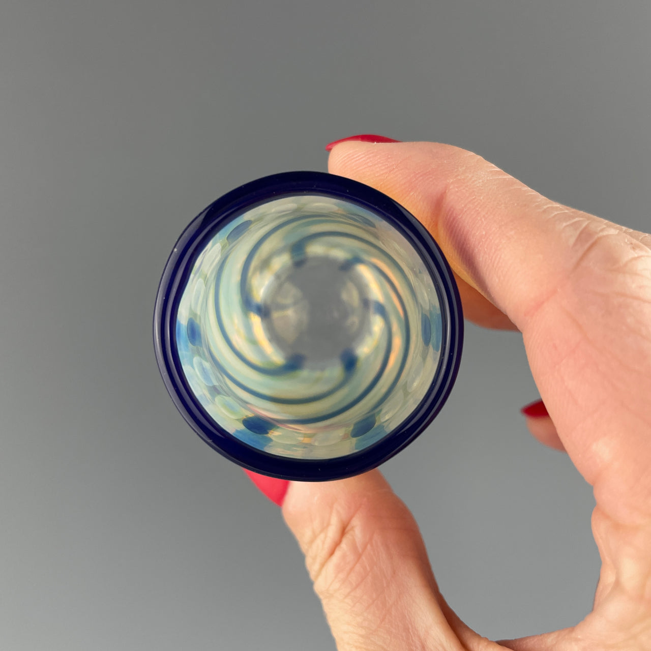 inside of a clear and blue swirls shot glass