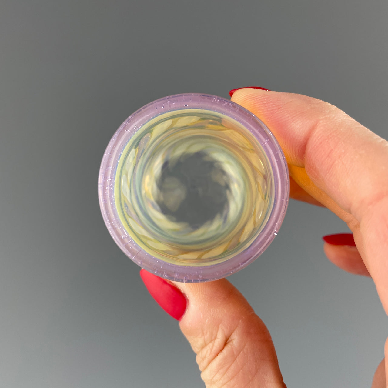 inside of a clear and purple sparkles shot glass