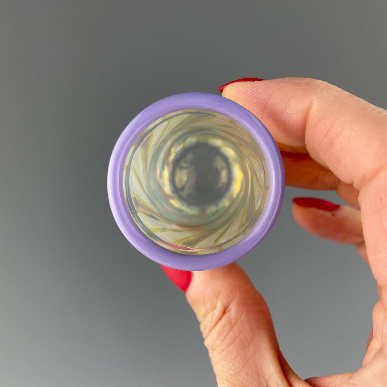 inside of a clear and purple swirls shot glass