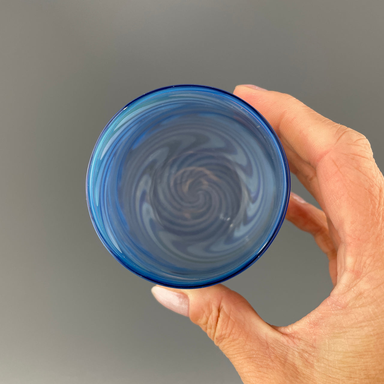 inside of a brilliant blue stemless wineglass