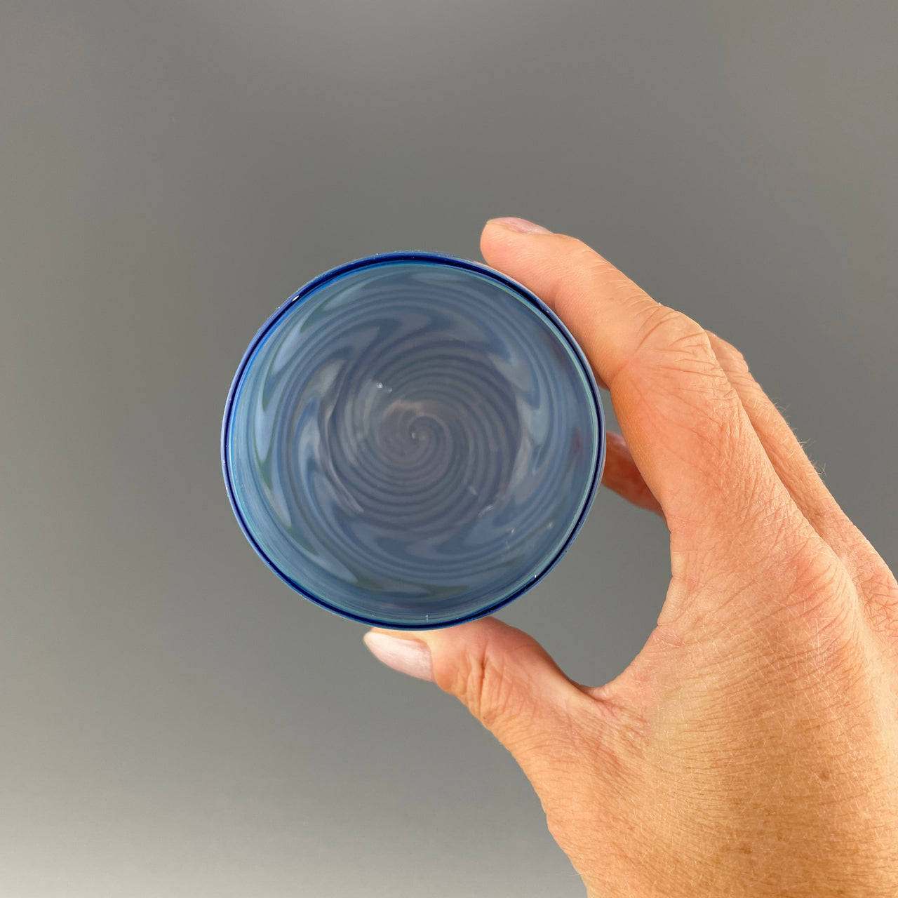 inside of a brilliant blue swirl stemless wineglass