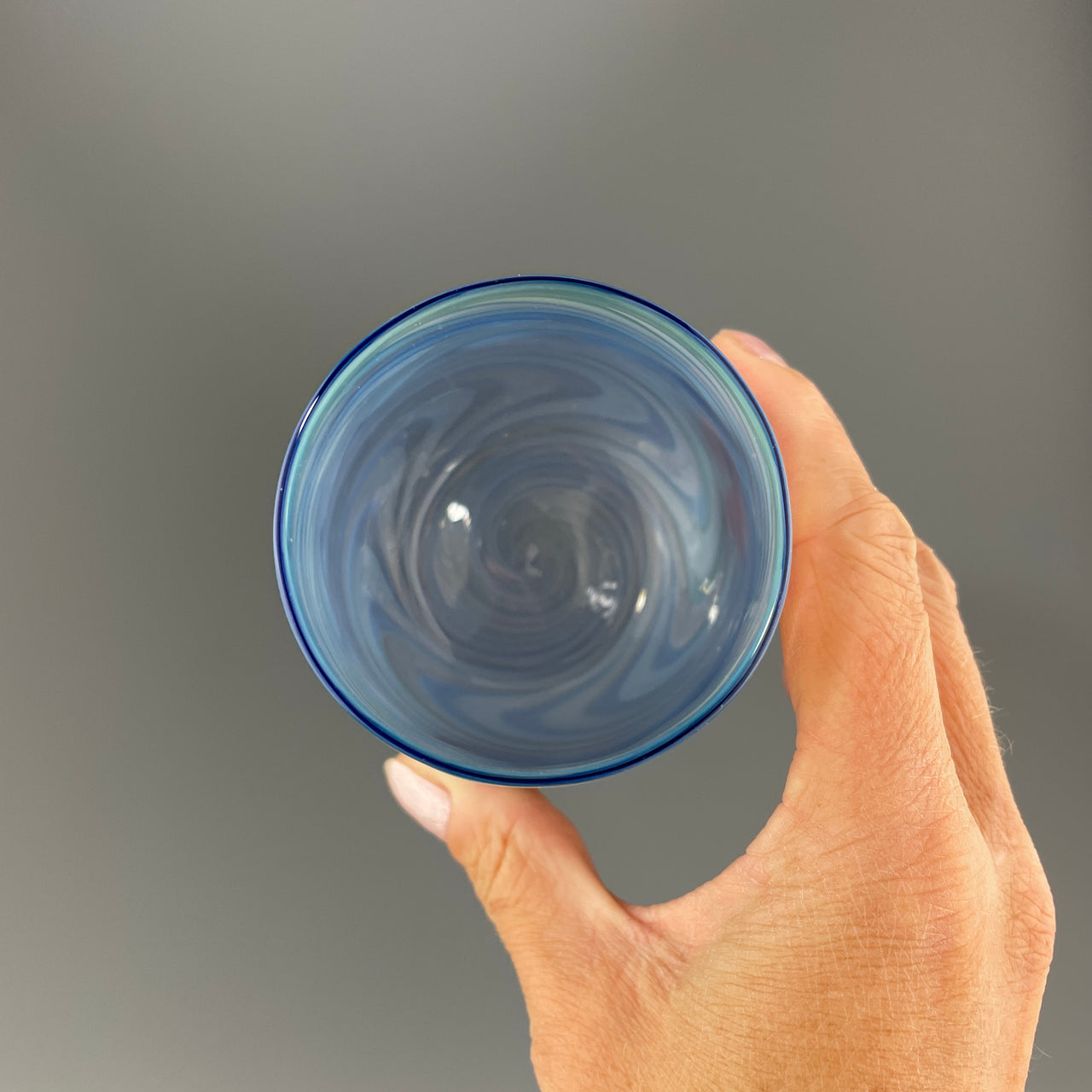 inside of a brilliant blue stemless wineglass