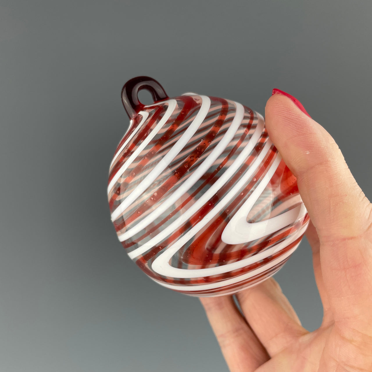 red and white swirled christmas bulb