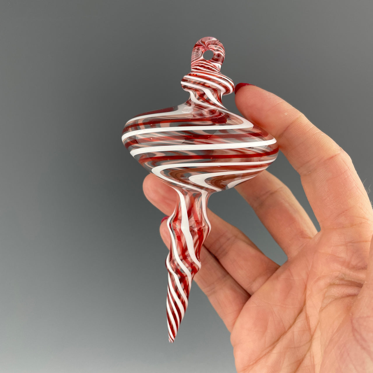 red, white, and swirled holiday ornament